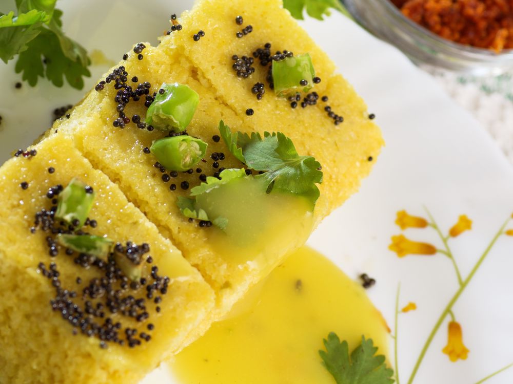 Khaman dhokla with mustard seeds, coriander and green chilli
