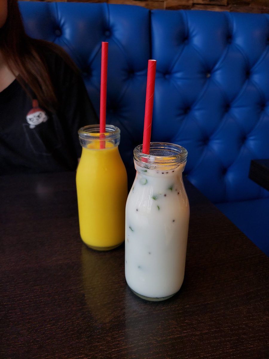 Mango lassi and buttermilk in glass bottles